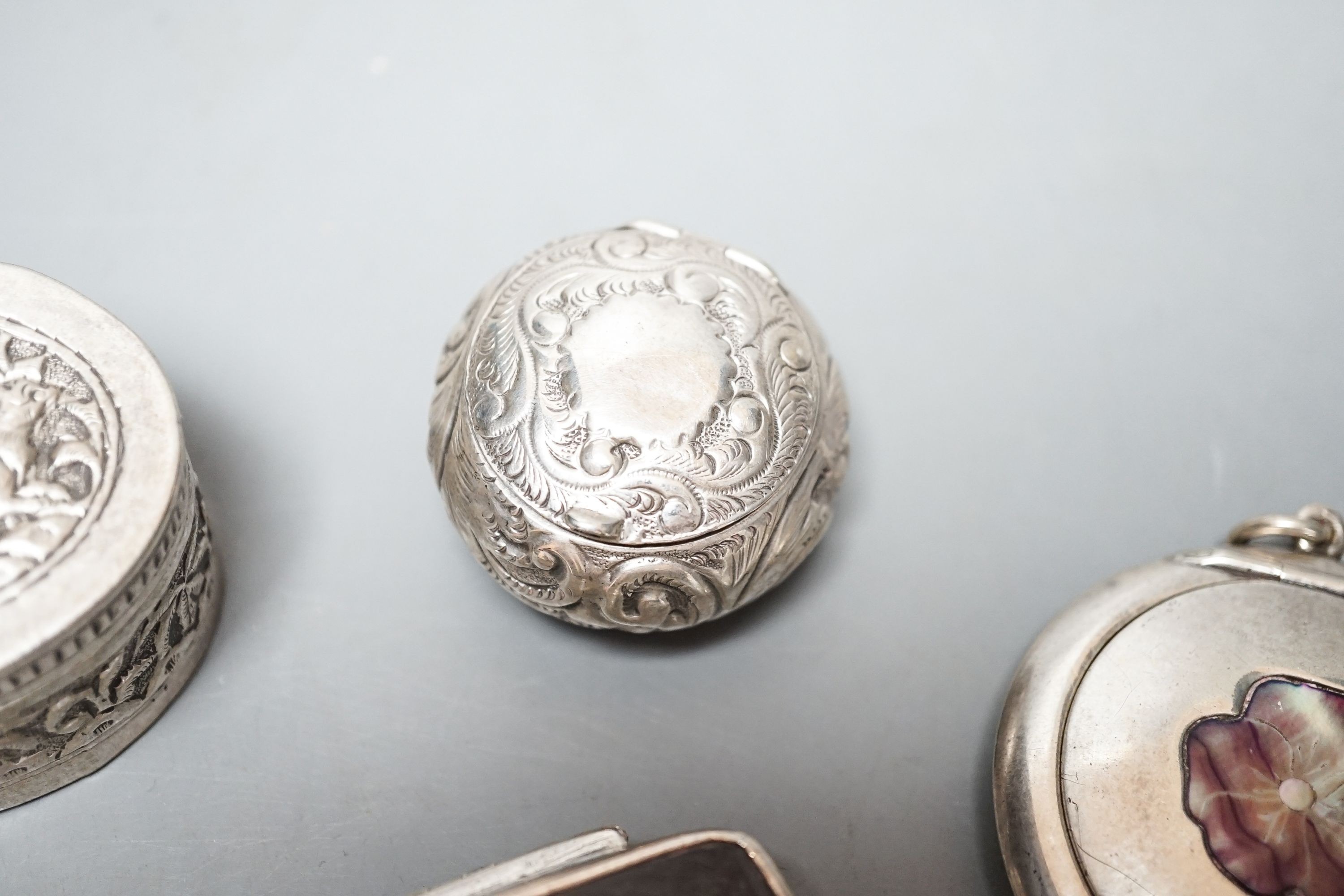 A selection of three small silver or white metal boxes to include a tortoiseshell pique box and a silver and shell inlaid compact.